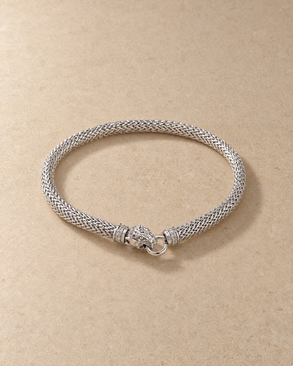 The silver-tone dragon bracelet in a still-life photograph